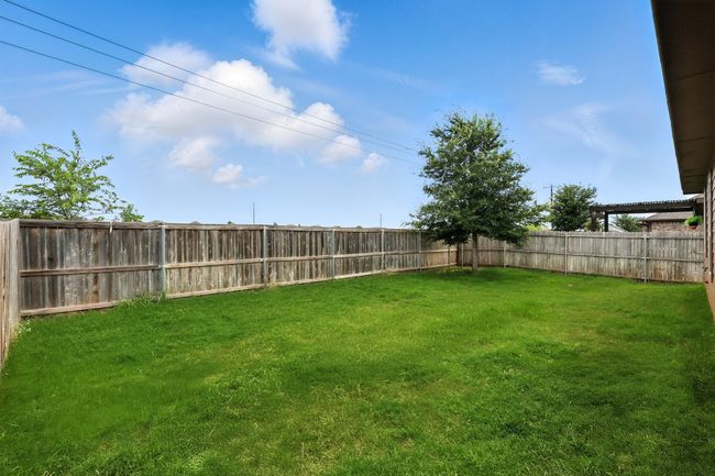 View of fenced backyard | Image 19
