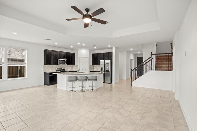 Kitchen featuring appliances with stainless steel finishes, dark cabinetry, backsplash, recessed lighting, and light countertops | Image 4
