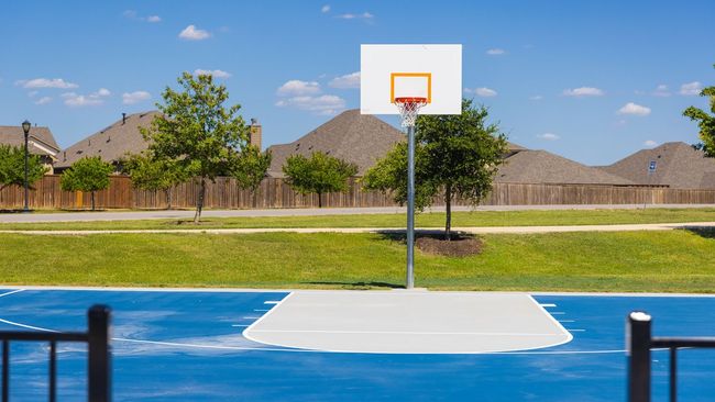 View of sport court featuring fence, a yard, and basketball hoop | Image 8