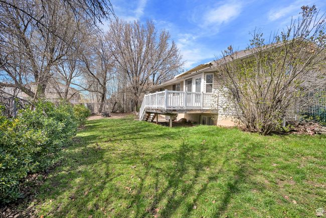View of yard featuring a wooden deck and stairway | Image 39