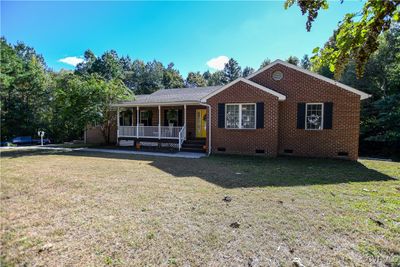 Ranch-style house with a front lawn and a porch | Image 1