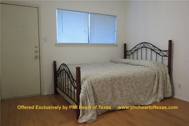 Large bedroom with window open to rear balcony | Image 4
