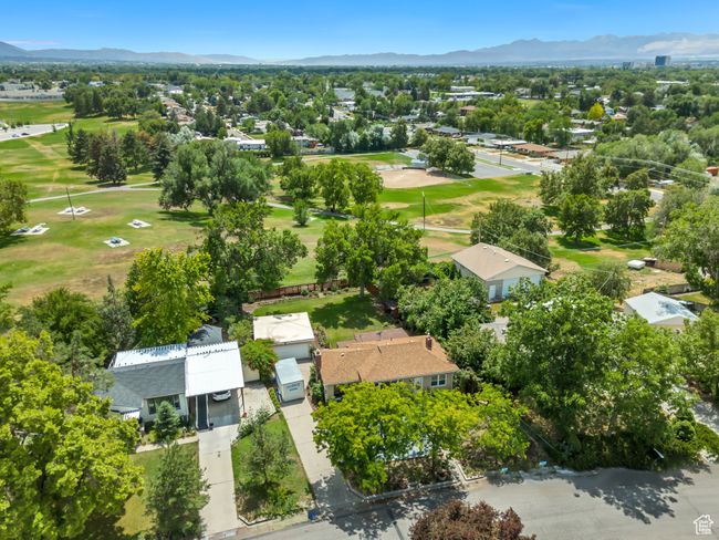 Aerial perspective of suburban area featuring a mountain backdrop and a local golf course | Image 34