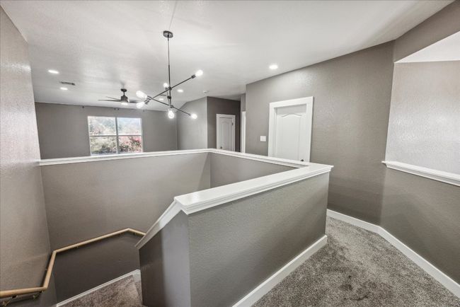 Staircase featuring baseboards, recessed lighting, a chandelier, visible vents, and carpet floors | Image 22