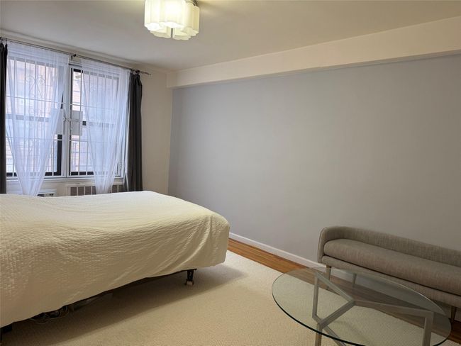 Bedroom with baseboards and wood finished floors | Image 7