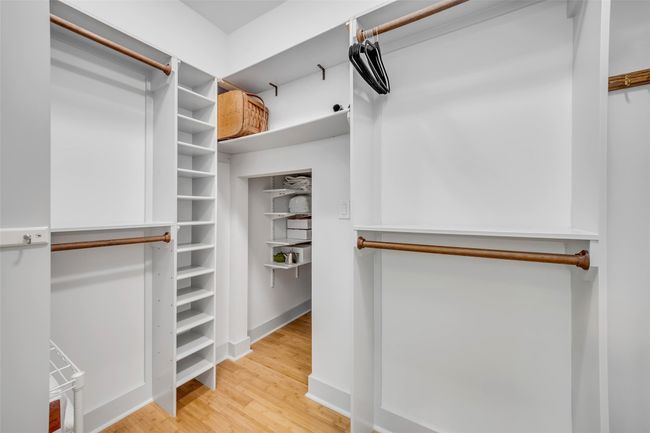 Spacious closet with light wood-type flooring | Image 18