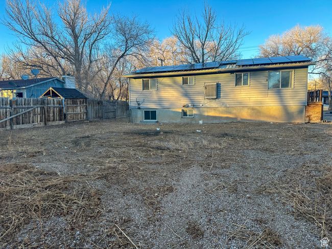 Rear view of house featuring solar panels | Image 17