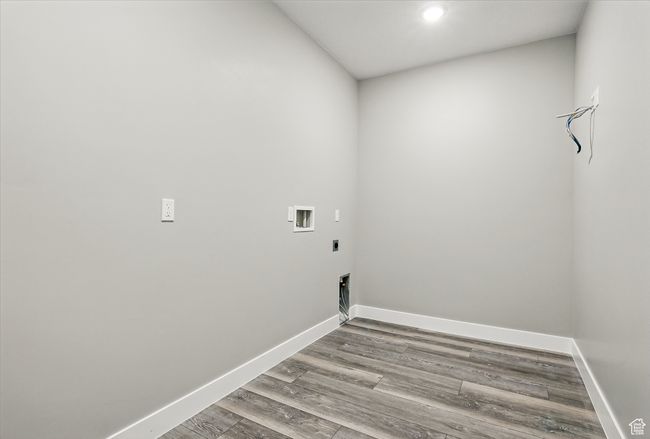 Laundry room with hookup for an electric dryer, wood finished floors, washer hookup, baseboards, and recessed lighting | Image 22