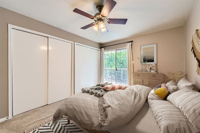 *Virtually Staged*Bedroom featuring carpet floors, access to outside, two closets, and ceiling fan | Image 9