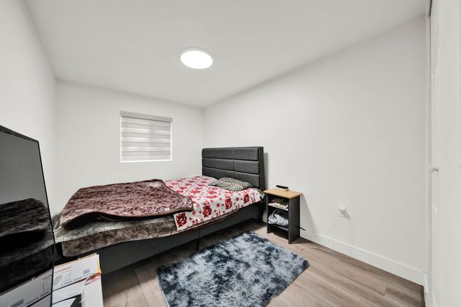 Bedroom featuring baseboards and wood finished floors | Image 12