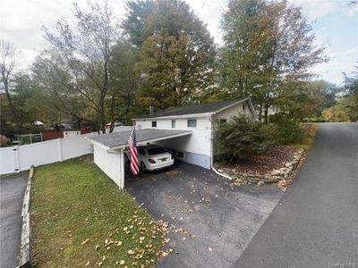 View of side of home featuring a yard and a carport | Image 2