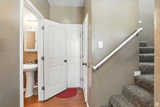 Stairs featuring wood finished floors and a textured wall | Image 14