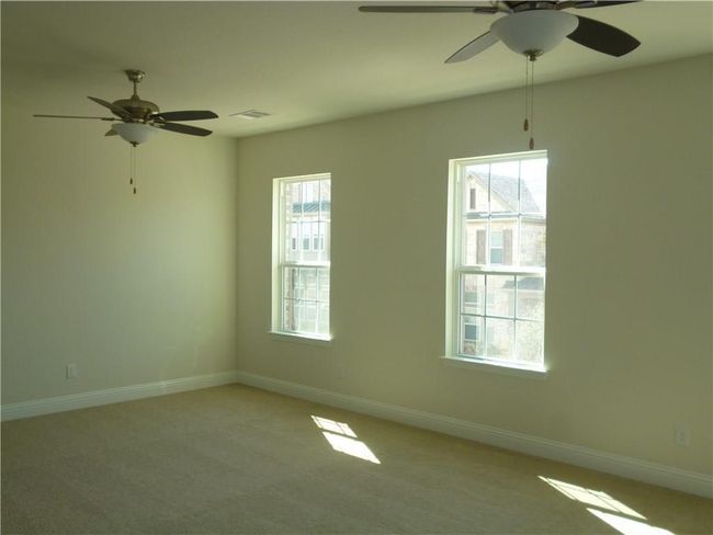 Unfurnished room featuring a ceiling fan, healthy amount of natural light, and baseboards | Image 9