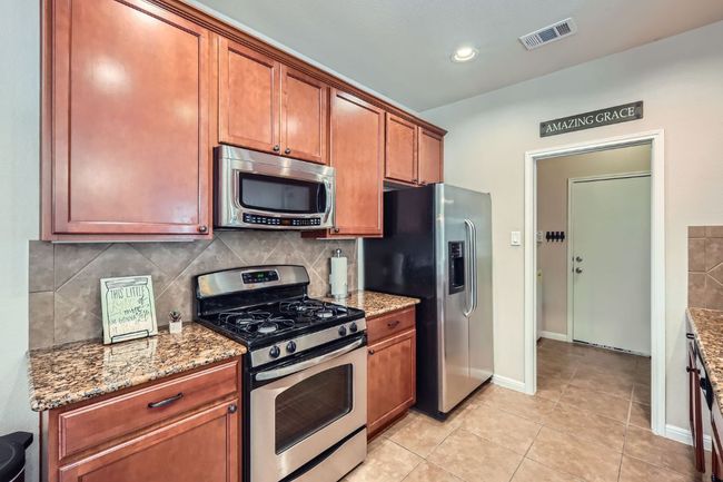 Nice galley type kitchen with stainless steel appliances. | Image 9