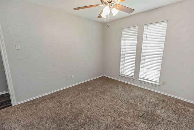 Spare room with carpet flooring, a ceiling fan, and baseboards | Image 23
