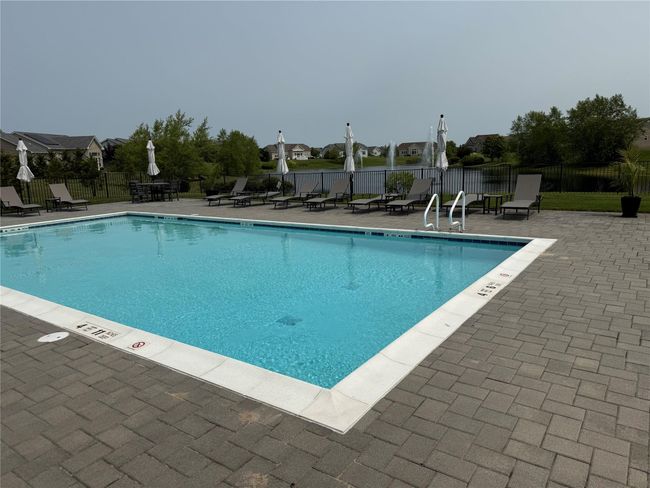 Community pool with a patio area | Image 26