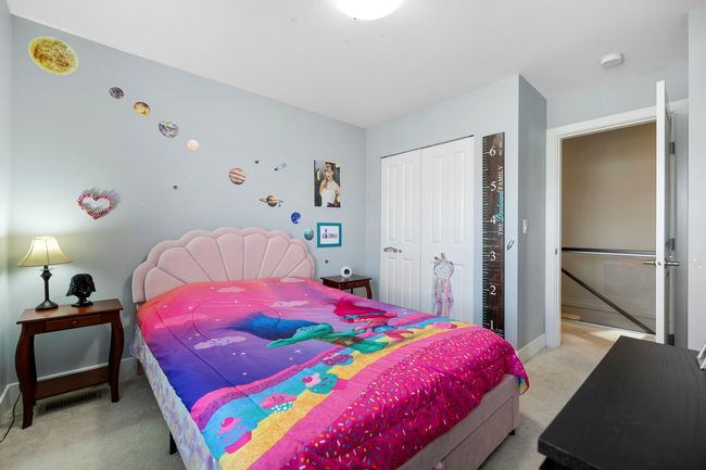 Bedroom with baseboards, a closet, and light carpet | Image 25