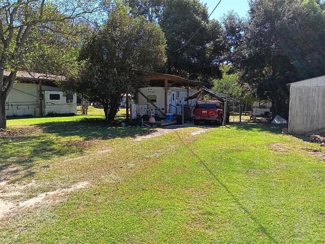 View of yard featuring a detached carport | Image 8