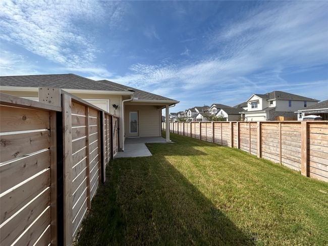 Fenced backyard with a residential view and a patio | Image 10