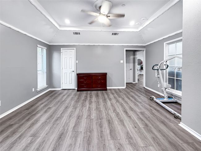 Workout area featuring wood finished floors, plenty of natural light, a raised ceiling, and vaulted ceiling | Image 32