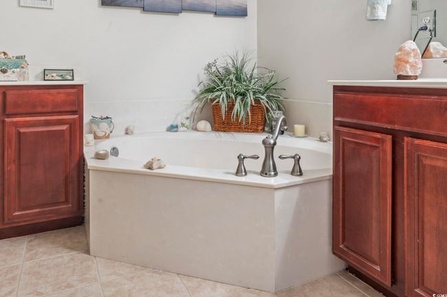 Bathroom featuring a bath, tile patterned floors, and vanity | Image 12