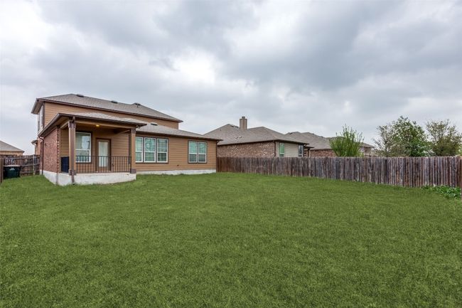 Back of house with a fenced backyard and a lawn | Image 24