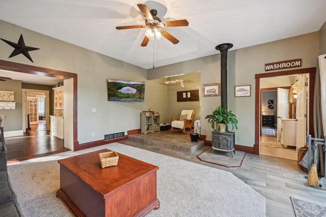 Here is another view of the family room. You can see the entrance to the kitchen, the dining room, and the front living room. On the right, you can see the walk-through bathroom to the primary bedroom. | Image 22