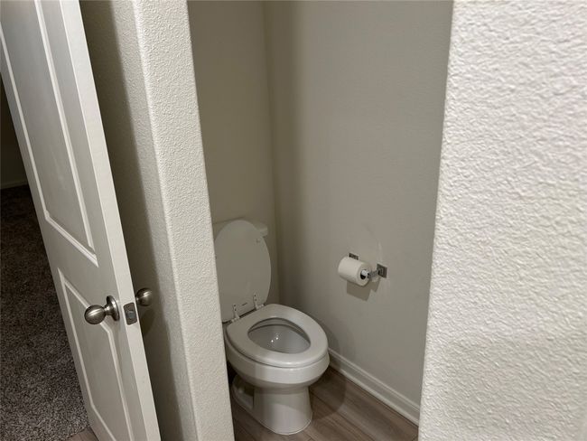 Bathroom featuring toilet, wood finished floors, and baseboards | Image 14