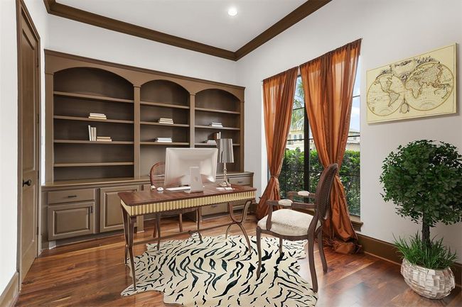 The dedicated home office or study features double entry doors, a built-in desk, and ample storage--- offering both functionality and sophistication in a private workspace. Virtually staged. | Image 10