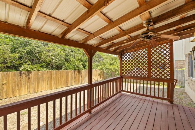 Wooden deck featuring ceiling fan and a fenced backyard | Image 31