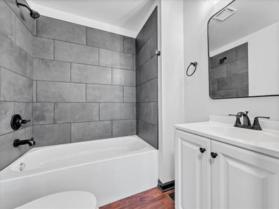 Full bathroom with tiled shower / bath, toilet, wood-type flooring, and vanity | Image 3