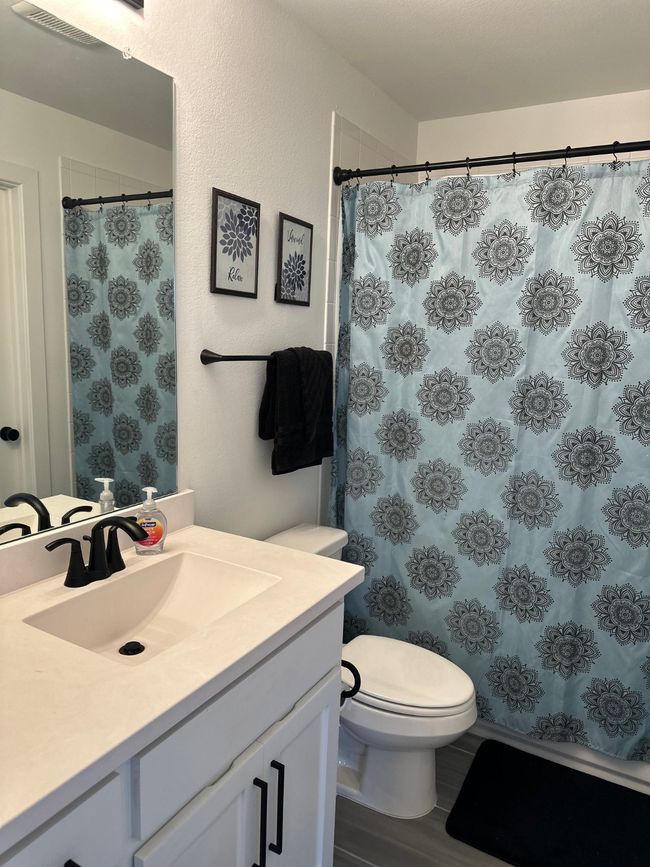 Full bath with a shower with shower curtain, vanity, and toilet | Image 34