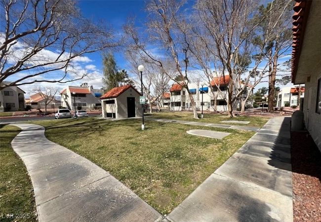 View of grassy yard with a residential view | Image 13