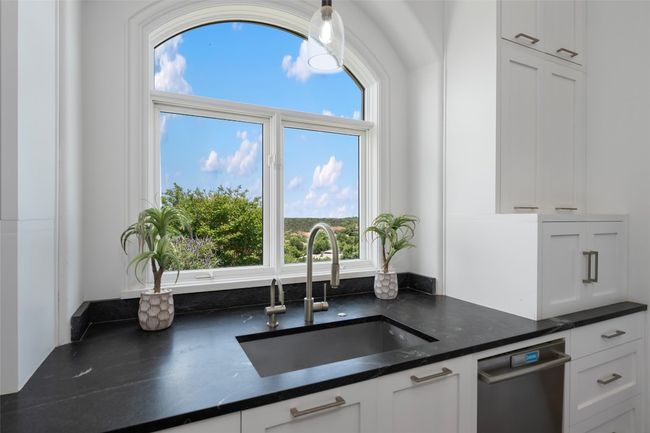 Kitchen with a sink, white cabinets, and plenty of natural light | Image 10