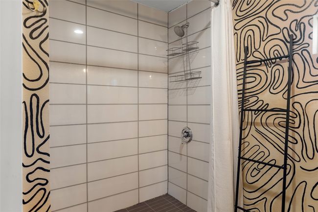 Bathroom featuring a shower with shower curtain | Image 26