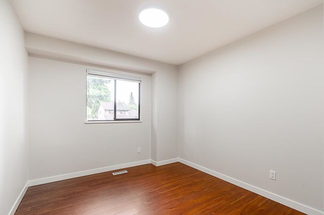 Spare room featuring baseboards and dark wood finished floors | Image 16
