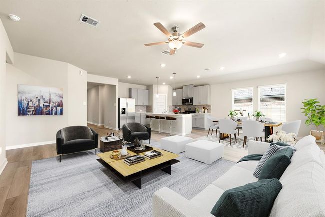 Large energy-efficient windows with blinds flood the space with natural light, while a sleek ceiling fan ensures year-round comfort. Plus, with seamless access to your stunning eat-in kitchen, hosting and everyday living have never been more enjoyable! | Image 5