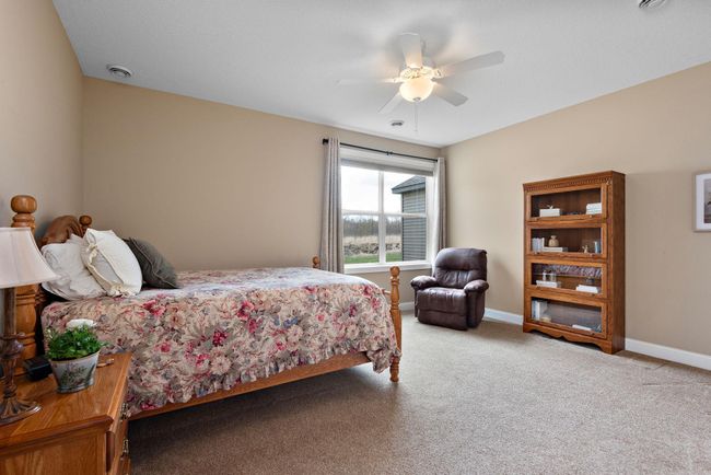 Gorgeous Primary/Owner's suite has heating floors, granite countertops, custom double vanity, walk-in closet with pocket door and walk-in shower with tile surround! | Image 12
