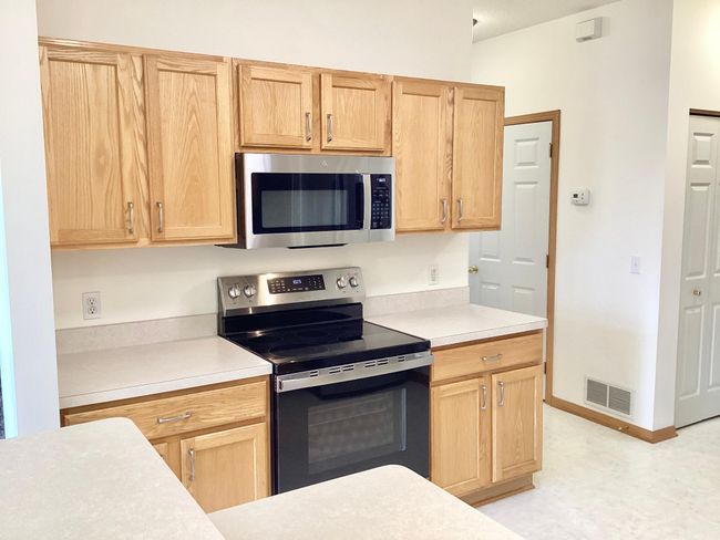 Oak cabinets, new range with built-in air fryer, new microwave. | Image 6