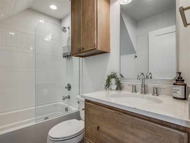 Bathroom with vanity, toilet, shower / washtub combination, and recessed lighting | Image 37