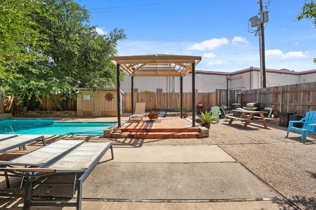 Fenced backyard with a patio, a pergola, and a storage unit | Image 33