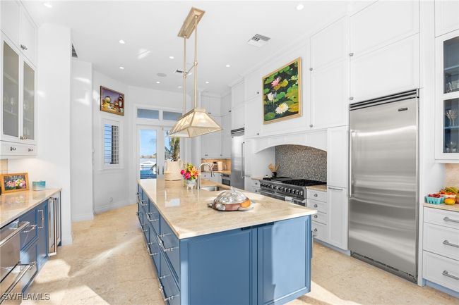 Kitchen - loads of elegant storage and french doors out to back patio and outdoor kitchen | Image 20