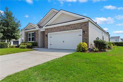 View of front of home with a front lawn and a garage | Image 2