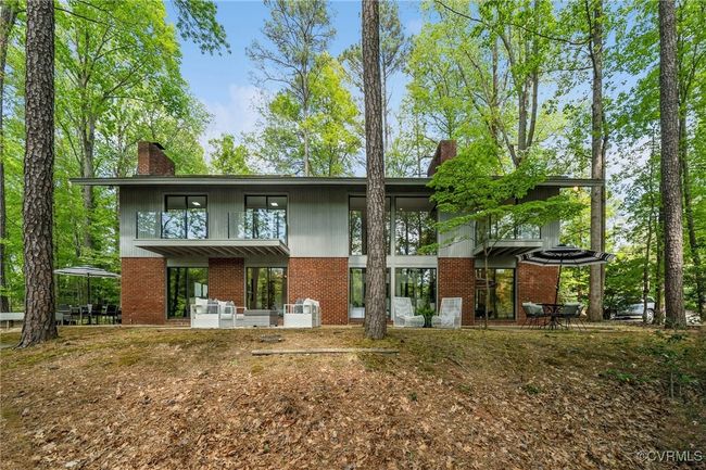 Back of house featuring a chimney, brick siding, and a patio area | Image 5