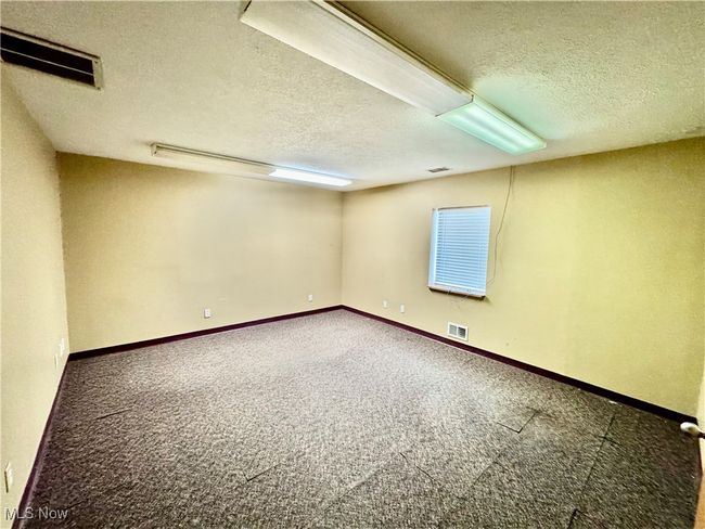 Carpeted spare room with a textured ceiling | Image 15