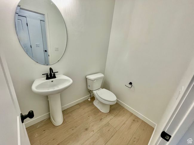 Half bathroom with wood finished floors and toilet | Image 9
