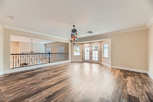 Empty room featuring ornamental molding, wood finished floors, ceiling fan, and a smoke detector | Image 35