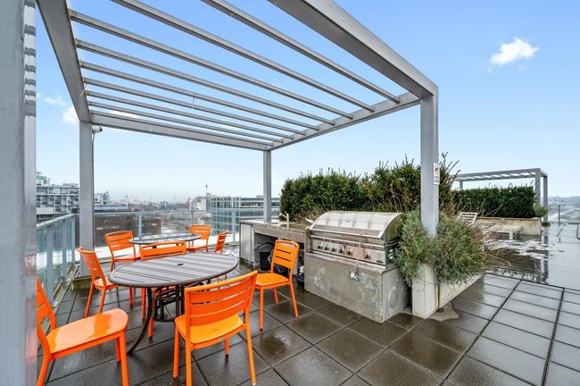 View of patio / terrace featuring a pergola, exterior kitchen, and area for grilling | Image 15