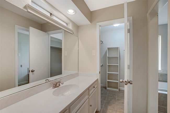 Bathroom featuring vanity, a walk in closet, and tile patterned floors | Image 10