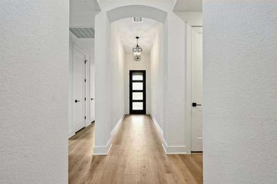 Representative Photo - Arched Hallways throughout the Entryway | Image 3